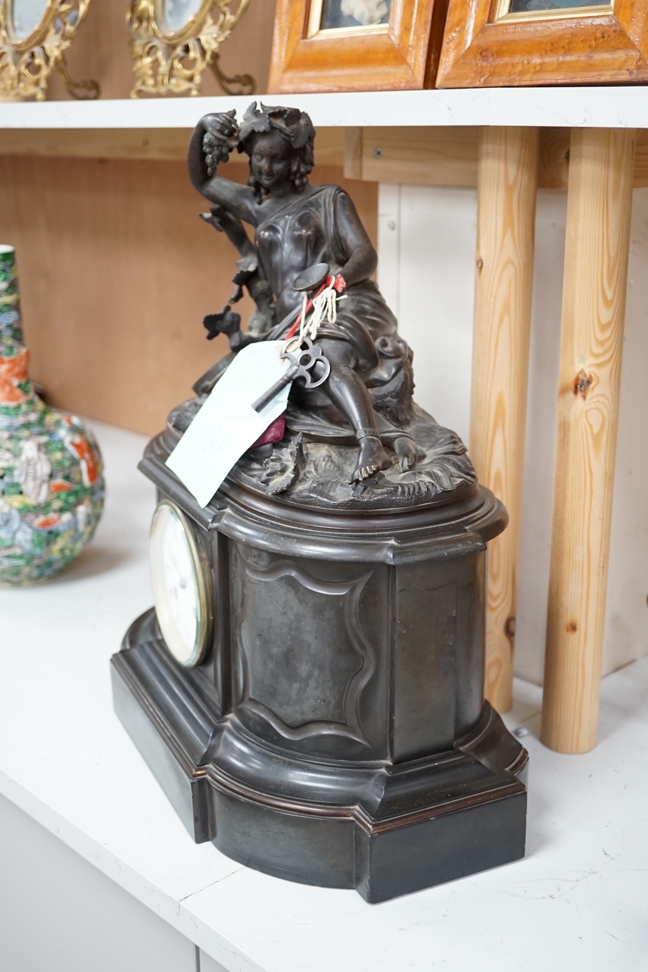 A Victorian black marble eight day mantel clock, surmounted by a cast bronze figure of a muse, with key, 48cm high. Condition - fair, untested